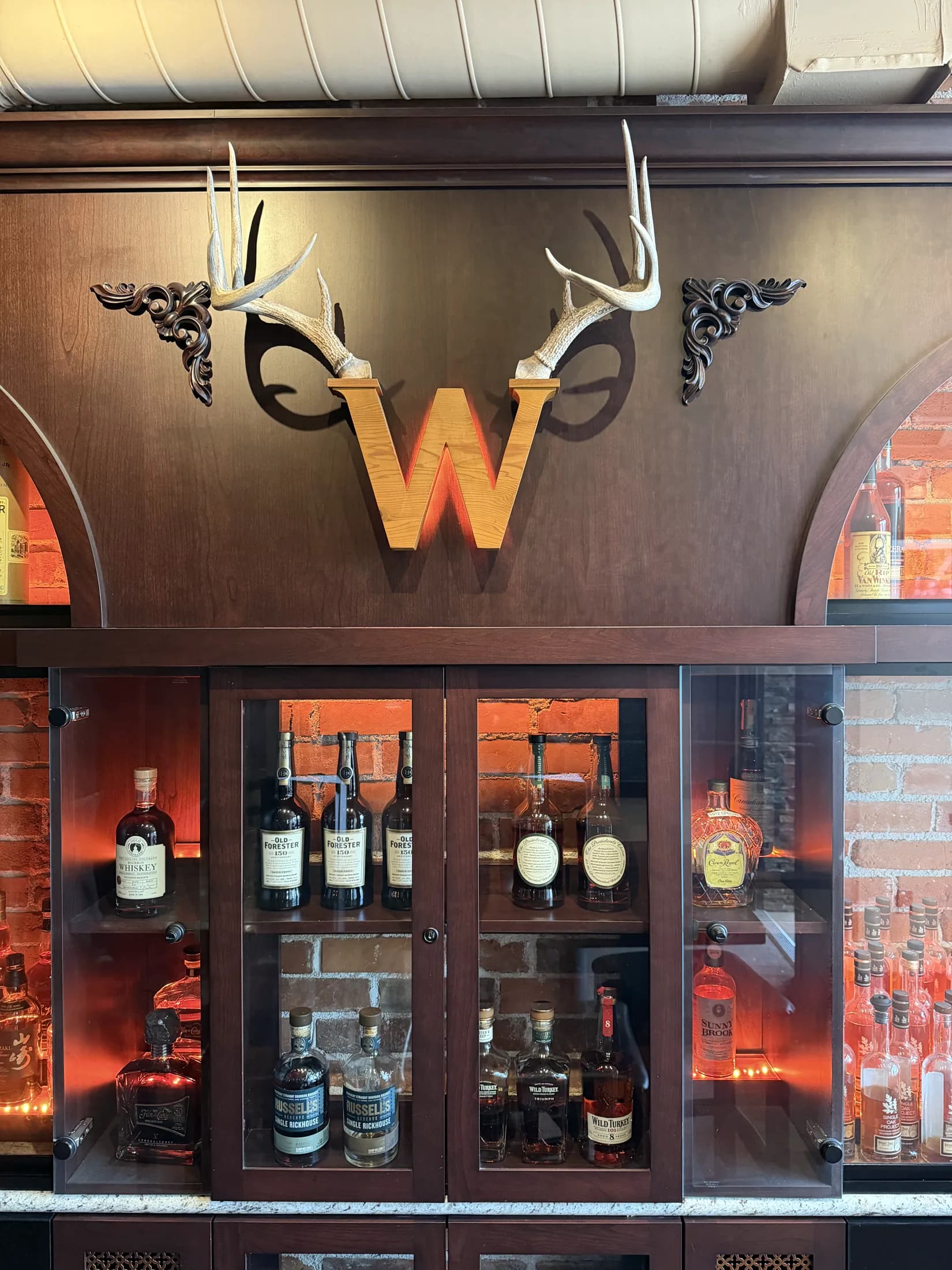 The official Whisk(e)y antler W over the back bar
